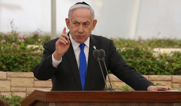 Israeli Prime Minister Benjamin Netanyahu speaks during a ceremony at the Nahalat Yitzhak Cemetery in occupied Palestine, Tuesday, June 18, 2024 (AP)