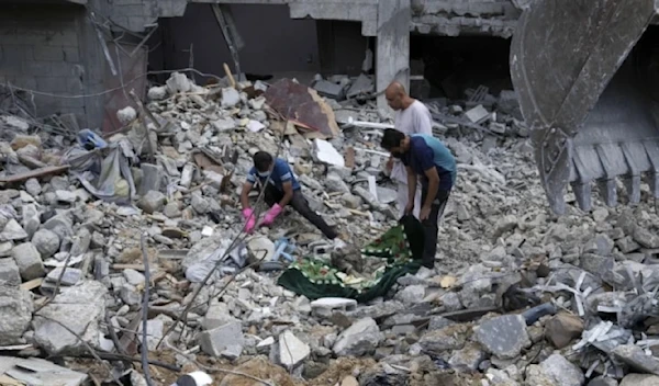 Palestinians recover the bodies of the al Meghari family including children killed in the Israeli bombardment of the Gaza strip in Bureij refugee camp, Gaza Strip, Tuesday, Nov. 14,2023. (AP)