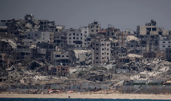 Destroyed buildings stand in the coast of the Gaza Strip as seen from the Mediterranean Sea, Tuesday, June 25, 2024. (AP Photo/Leo Correa)