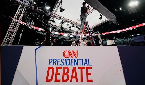 A lighting tech for CNN, sets up lights for the presidential debate between President Joe Biden and former President Donald Trump in Atlanta, Wednesday, June 26, 2024. (AP)