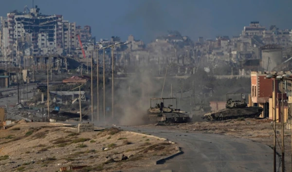 Israeli army tanks are seen in Wadi Gaza, central Gaza Strip, Wednesday, June 26, 2024. (AP Photo/Abdel Kareem Hana)