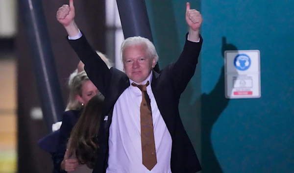 WikiLeaks founder Julian Assange gestures after landing at RAAF air base Fairbairn in Canberra, Australia, Wednesday, June 26 2024. (AP)