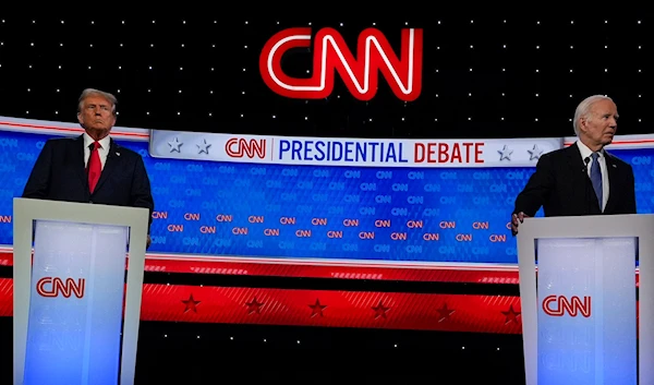 President Joe Biden, right, and Republican presidential candidate former President Donald Trump, left, stand during break in a presidential debate hosted by CNN, June 27, 2024, in Atlanta (AP)