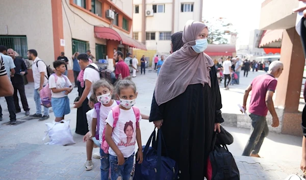 Palestinian children with chronic diseases stand next to their mother as they wait to leave the Gaza Strip for treatment abroad through the Karem Salem crossing, in Khan Younis, southern Gaza Strip, Thursday, June 27, 2024. (AP)