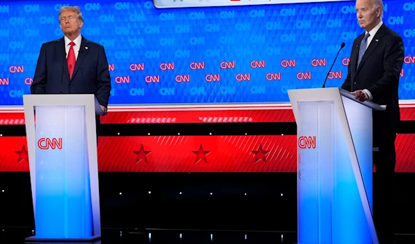 President Joe Biden, right, speaks as Republican presidential candidate former President Donald Trump, left, listens during a presidential debate hosted by CNN, June 27, 2024, in Atlanta (AP)