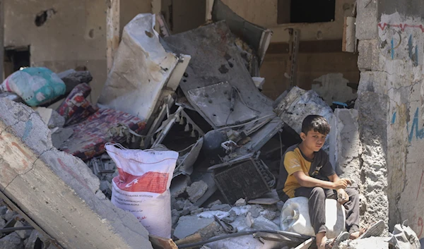 A Palestinian boy sits in the rubble of his destroyed home in Jabaliya, northern Gaza Strip after Israeli forces withdrew from the area, Friday, May 31, 2024. (AP)