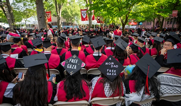 Students wear signs supporting Palestinians in Gaza on their mortarboards during commencement in Harvard Yard, at Harvard University, in Cambridge, Mass., Thursday, May 23, 2024. (AP)