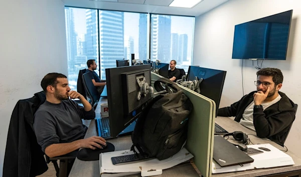 Employees of Pyramid Analytics hi-tech company work at their office in Ramat Gan, occupied Palestine, Wednesday, Jan. 18, 2023. (AP)