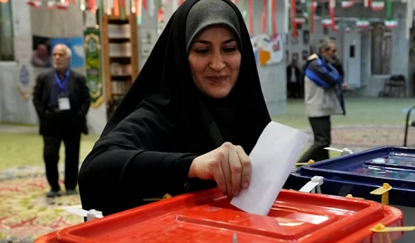 A woman casts her ballot during the parliamentary and Assembly of Experts elections at a polling station in Tehran, Iran, Friday, March 1, 2024. (AP)