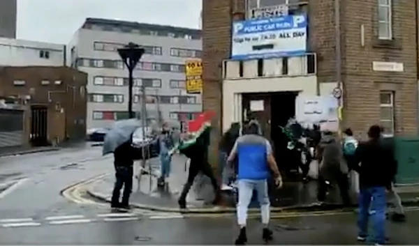 Screenshot of a video showing an attack on a woman attempting to vote. (Social media)