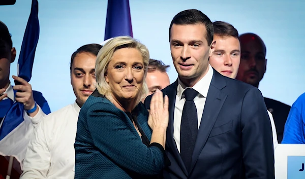 Leader of the French far-right National Rally Marine Le Pen, left, and lead candidate of the party for the upcoming European election Jordan Bardella during a political meeting on June 2, 2024 in Paris. (AP)