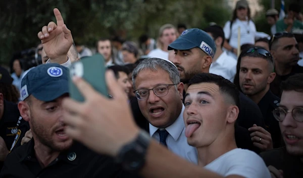 An Israeli settler takes a selfie with the Israeli occupation Police Minister Itamar Ben-Gvir, on Wednesday, June 5, 2024. (AP)