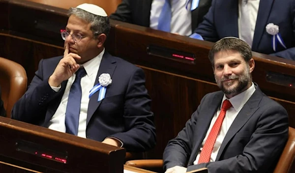 In this photo taken on November 15, 2022, then-Knesset members Itamar Ben-Gvir (L) and Bezalel Smotrich look on during the swearing-in ceremony for Israeli lawmakers in al-Quds. (AP)