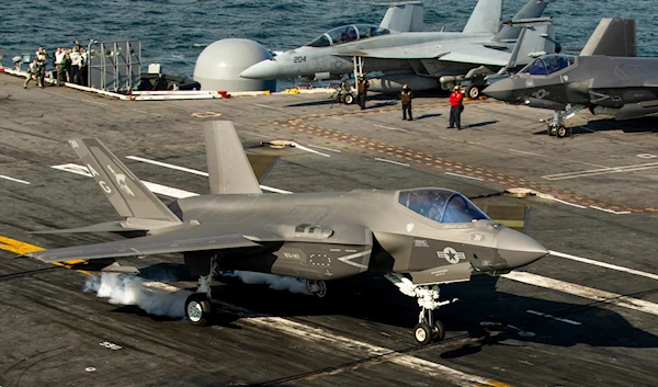 An F-35 fighter jet lands on the deck of the nuclear-powered aircraft carrier USS George Washington during joint exercises off the coast of Argentina, May 30, 2024 (AP)