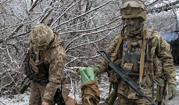 Illustrative: Ukrainian soldiers handle equipment outside Kharkiv, Ukraine, Feb. 26, 2022. (AP)