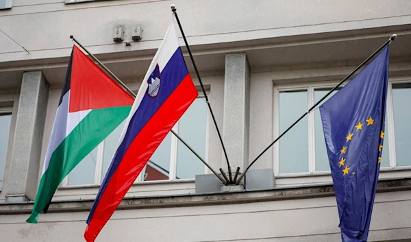 A Palestinian flag flies next to a Slovenian, center, and a European Union flag, right, at the government building in Ljubljana, Slovenia, Thursday, May 30, 2024 (AP)