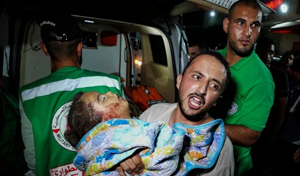 A Palestinian relative moves a child of Rewan Ghanem killed in an Israeli bombardment on a residential building owned by the Ghanem family in al-Bureij refugee camp, at al-Aqsa Martyrs hospital in Deir al-Balah, central Gaza, June 4, 2024. (AP)