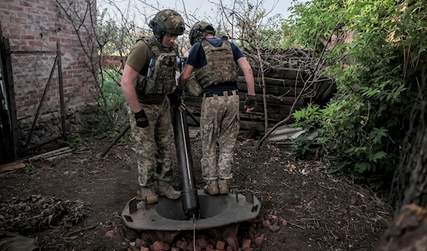 Ukrainian soldiers prepare to fire 120mm mortar towards Russian position on the front line at undisclosed location in Donetsk region, Ukraine, on June 4, 2024. (AP)