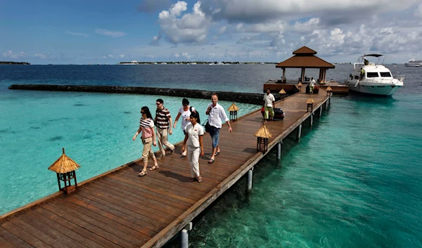 Foreign tourists arrive in a resort in the Kurumba island in Maldives, Feb. 12, 2012. (AP)