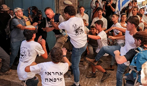 Israeli settlers assault Palestinian freelance journalist Saif Kwasmi on June 5, 2024, during the so-called Jerusalem Day Flag March. (AFP)