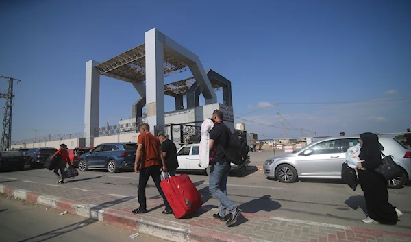 Palestinians wait to cross to the Egyptian side at Rafah border, Gaza Strip, on October 16, 2023. (AP)