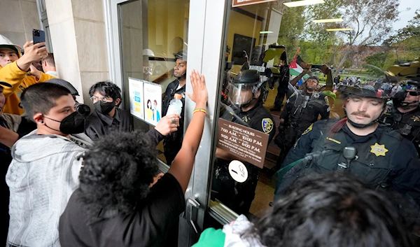 Police block Pro-Palestinian demonstrators from entering a building on the UCLA campus, May 23, 2024, in Los Angeles, the United States (AP)