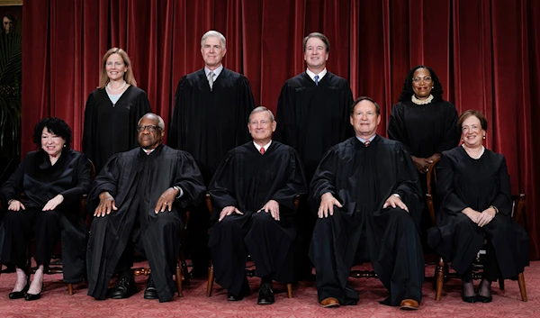 Members of the Supreme Court sit for a new group portrait following the addition of Associate Justice Ketanji Brown Jackson, at the Supreme Court building in Washington, the United States, October 7, 2022 (AP)