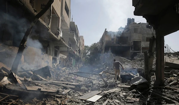 Palestinians look at the aftermath of the Israeli bombing in Nuseirat refugee camp, Gaza Strip, Saturday, June 8, 2024 (AP Photo/Jehad Alshrafi)