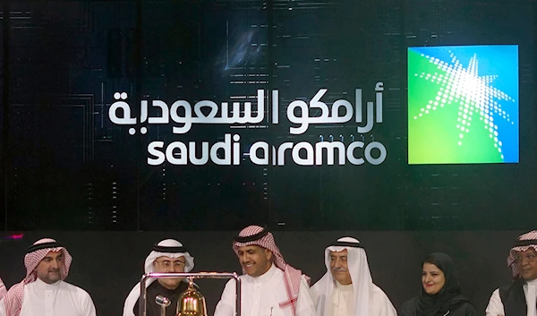 Saudi Arabia's state-owned oil company Aramco and stock market officials celebrate the debut of Aramco's initial public offering on the Riyadh Stock Market in Saudi Arabia, Dec. 11, 2019. (AP)