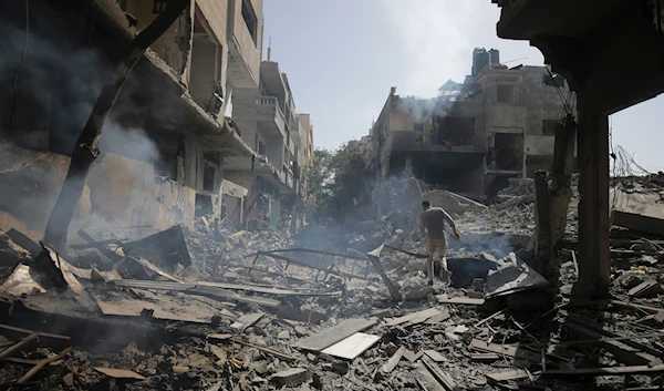 Palestinians look at the aftermath of the Israeli bombing in the Nuseirat refugee camp, Gaza Strip, June 8, 2024 (AP)