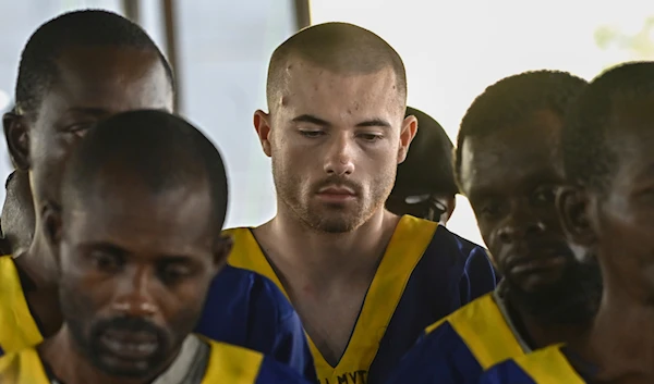 American Tyler Thompson Jr, center, sits in court in Kinshasa, Friday, June 7, 2024. (AP)