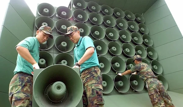 South Korean soldier tear down a battery of propaganda loudspeakers along the border with North Korea in Paju on June 16, 2004. (AFP/Getty Images)