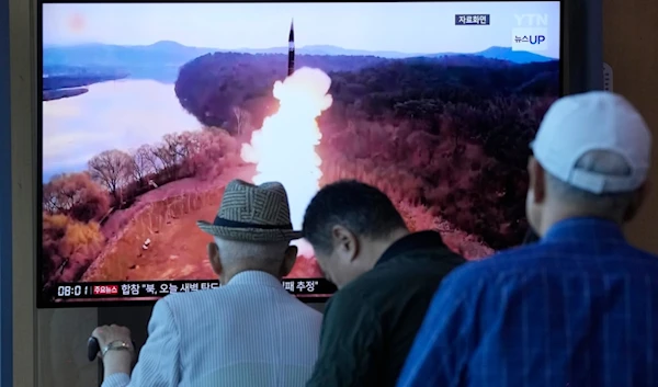 People watch a news program broadcasting a file image of a missile launch by DPRK, at Seoul Railway Station in Seoul, South Korea, Wednesday, June 26, 2024. (AP)