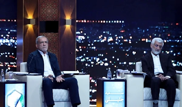 Masoud Pezeshkian, center, speaks in a debate of the candidates as Saeed Jalili listens at the TV studio in Tehran, Iran, Monday, June 17, 2024. (Morteza Fakhri Nezhad/IRIB via AP)