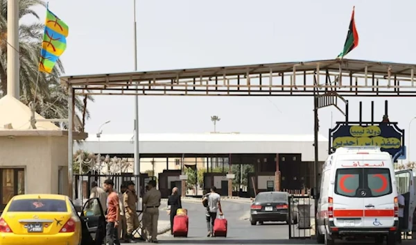 Vehicles cross from Libya into Tunisia at Ras Ajdir border crossing in 2021. AFP