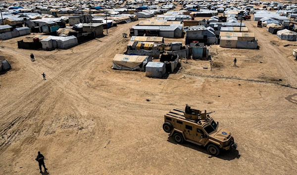 Kurdish forces patrol al-Hol camp, which houses families of members of the Islamic State group in al-Hasakeh province, Syria, on April 19, 2023 (AP)