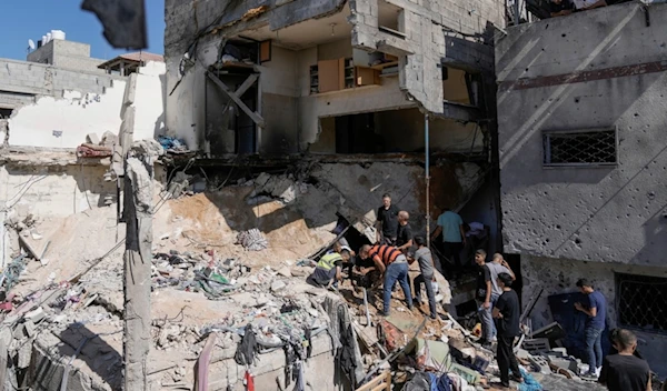 Palestinians inspect the destruction following an Israeli assassination operation in Nur Shams refugee camp, near the West Bank town of Tulkarm, occupied Palestine, June 30, 2024. (AP)