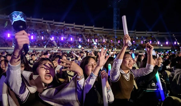 Audience cheering for a professional K-pop band performing between rounds of amateurs, undated. (AFP)