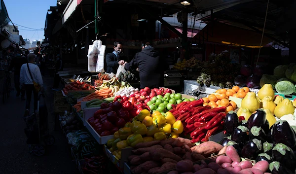 Israeli shop at a market in 'Tel Aviv', occupied Palestine, on February 21, 2021. (AP)