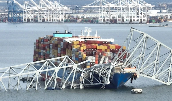 The Francis Scott Key Bridge sits on top of a cargo ship after the bridge collapsed in Baltimore on March 26, 2024. (AFP)