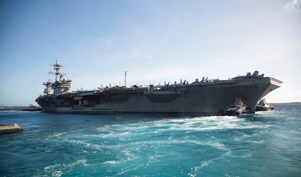 In this photo provided by the U.S. Marine Corps, the aircraft carrier USS Theodore Roosevelt (CVN 71) departs Apra Harbor at Naval Base Guam on Thursday, May 21, 2020. (US Marine Corps via AP)