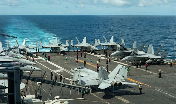 In this photograph released by the U.S. Navy, the flight deck of the Nimitz-class aircraft carrier USS Theodore Roosevelt is seen July 4, 2024, in the South China Sea.