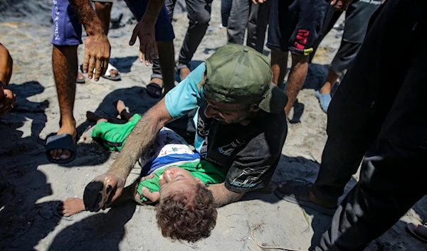 A Palestinian man mourns over the body of his child killed at a site hit by an Israeli occupation's bombardment on Khan Younis, southern Gaza Strip, Palestine, July 13, 2024. (AP)