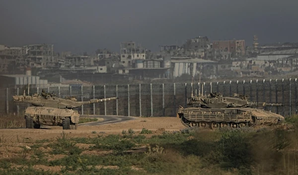 Israeli tanks stand near the Israel-Gaza border as seen from southern Israel Sunday, July 14, 2024. (AP Photo/Tsafrir Abayov)