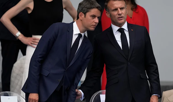 French President Emmanuel Macron, right, and French Prime Minister Gabriel Attal attend the Bastille Day parade Sunday, July 14, 2024 in Paris. (AP)