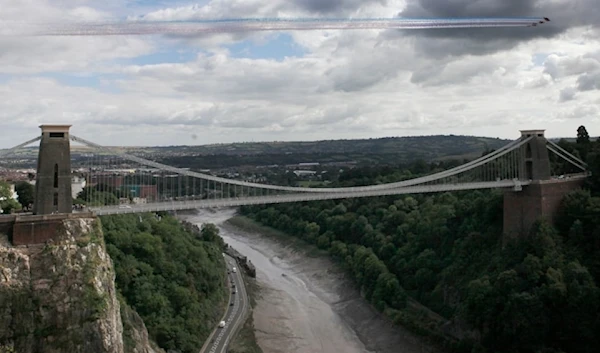 The Red Arrows display over the Clifton Suspension Bridge during the 35th annual Bristol International Balloon Fiesta in Bristol on Friday, August 9,2013. (AP)