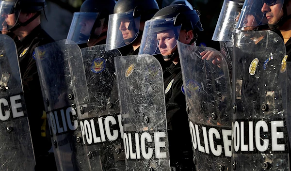 Phoenix Police officers watch protesters rally on June 2, 2020, in Phoenix, during demonstrations over the death of George Floyd. (AP)