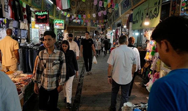 People walk through the Tajrish traditional bazaar in northern Tehran, Iran, Tuesday, July 2, 2024. (AP)