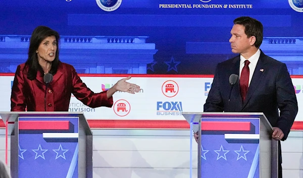 former U.N. Ambassador Nikki Haley, left, with Florida Gov. Ron DeSantis, speaks during a Republican presidential primary debate hosted by FOX Business Network and Univision, Sept. 27, 2023 (AP)