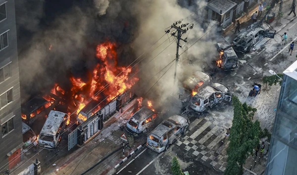 Smoke rises from the burning vehicles after protesters set them on fire during protests in Dhaka on July 18, 2024. (AFP)